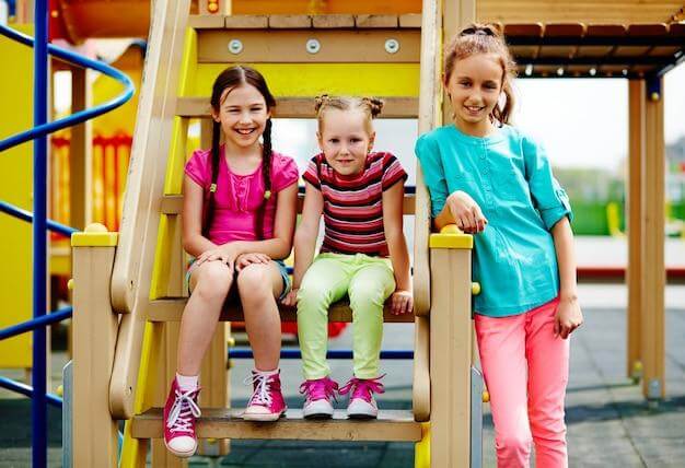 Happy girls sitting on the steps